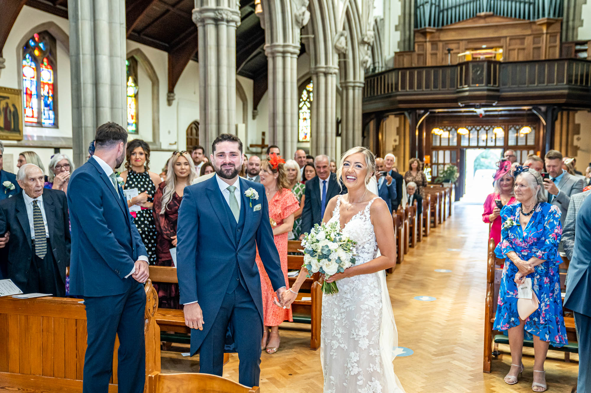 Bride and groom smile together.