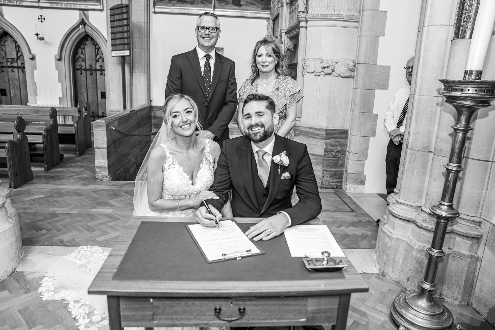 Newlyweds sign the register.