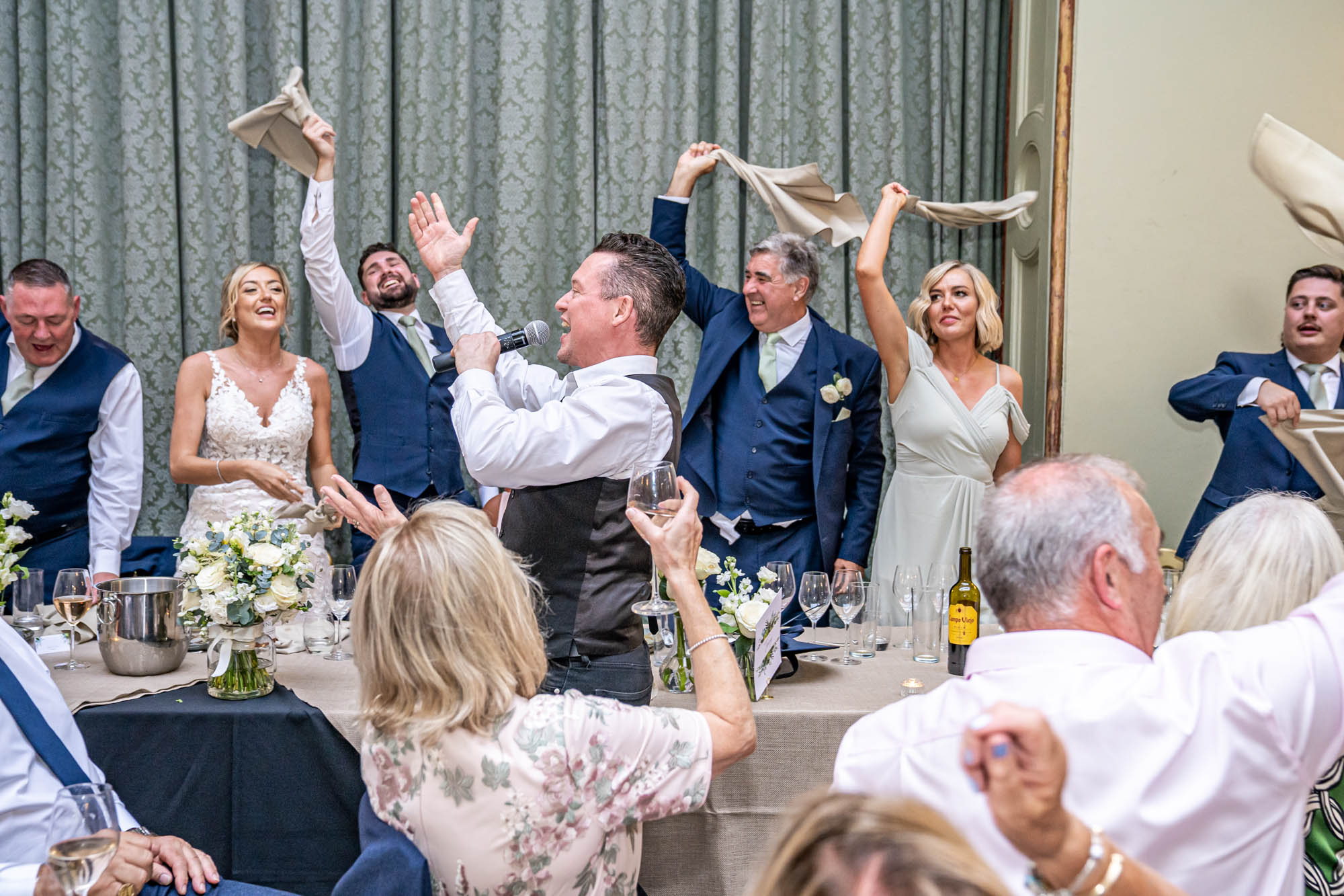 Guests wave their napkins in the air to music.