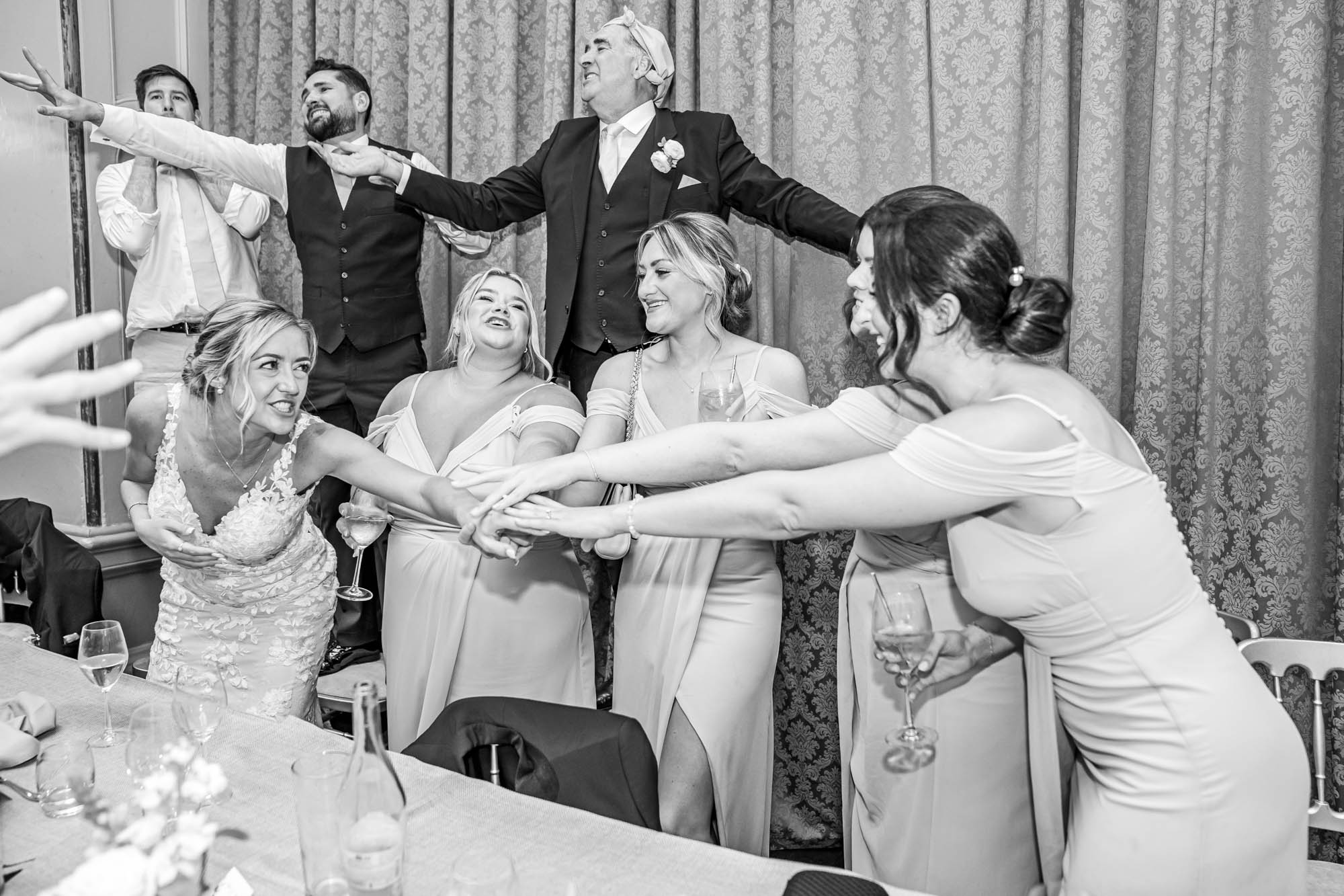 Wedding party dance together.