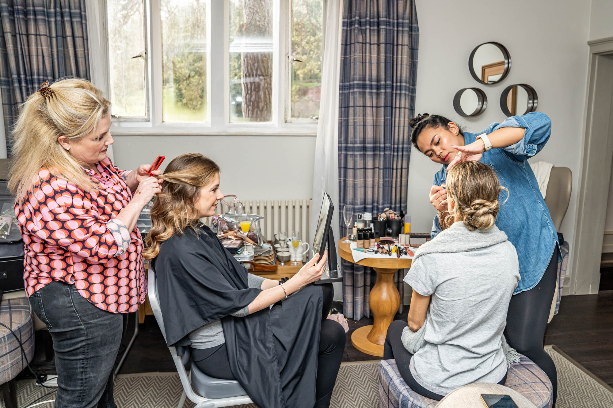 Bridesmaids having their hair and makeup done 