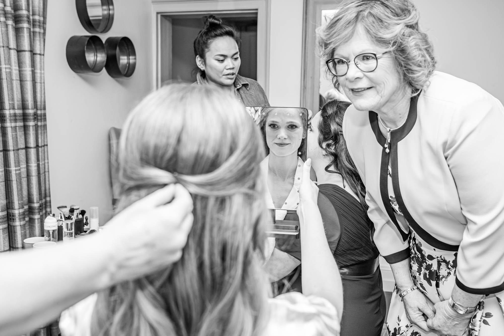 Mother of the bride watching her daughter get ready.