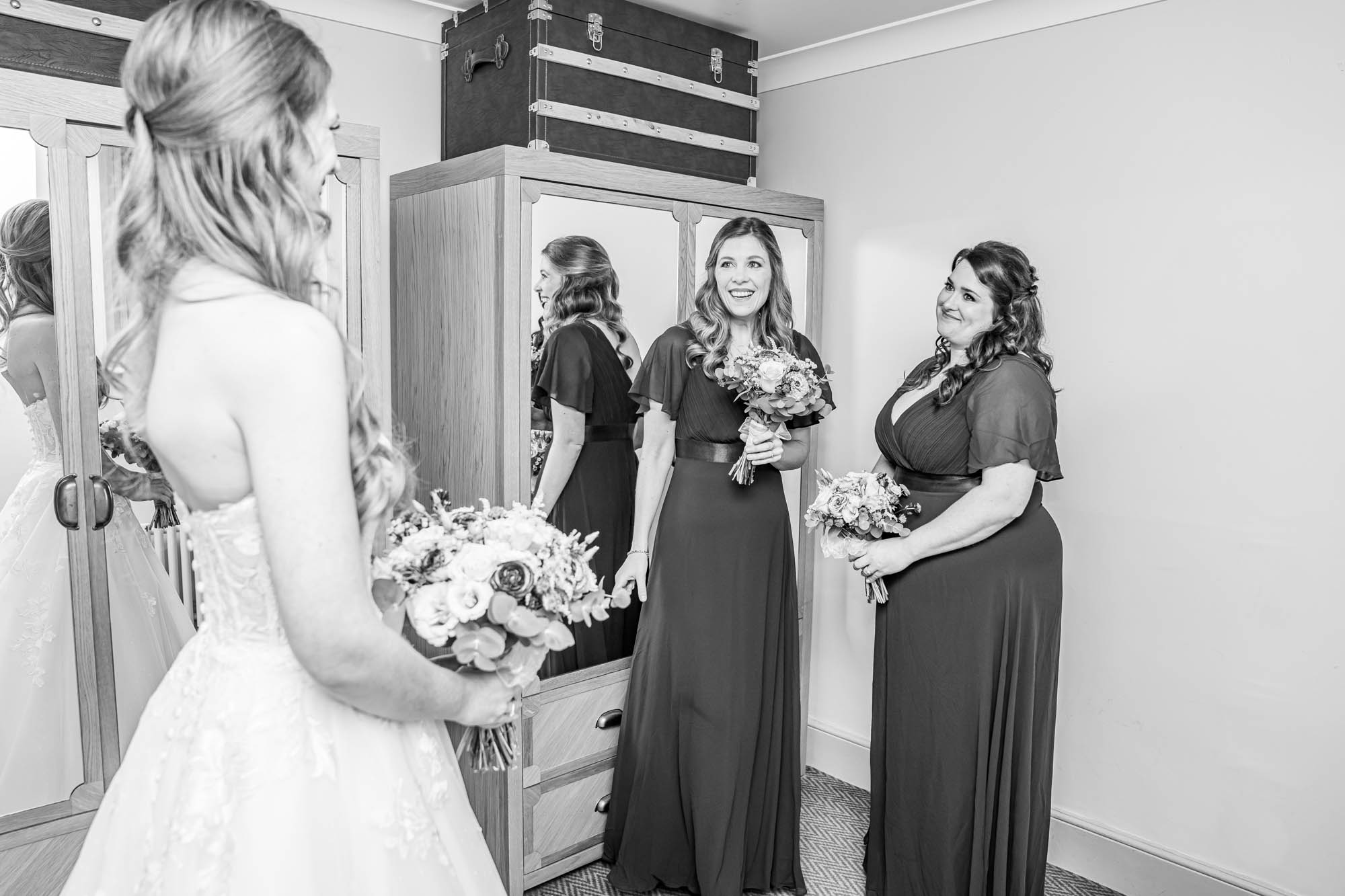 Brides dress reveal to bridesmaids.