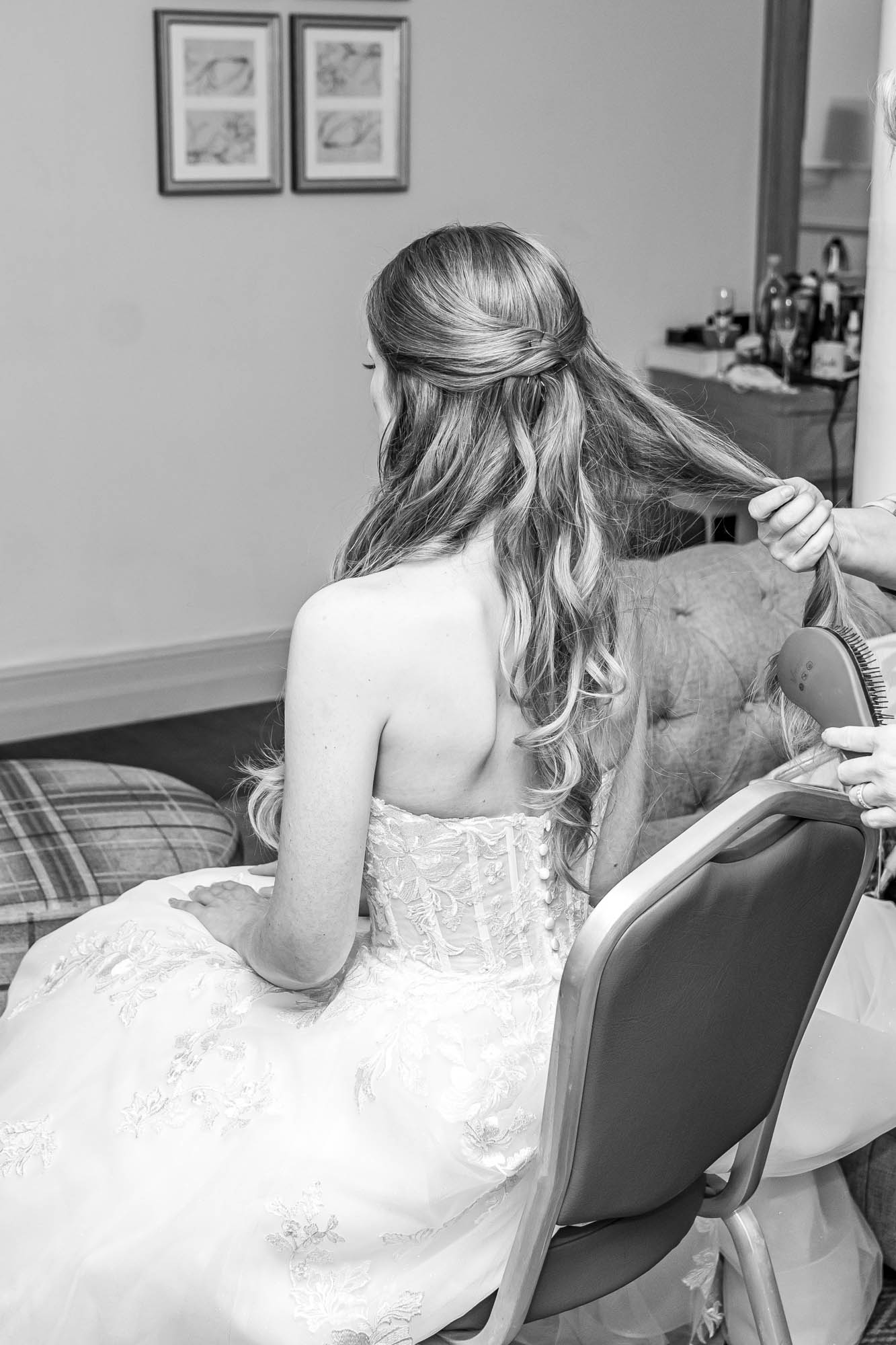 Bride having her hair styled 