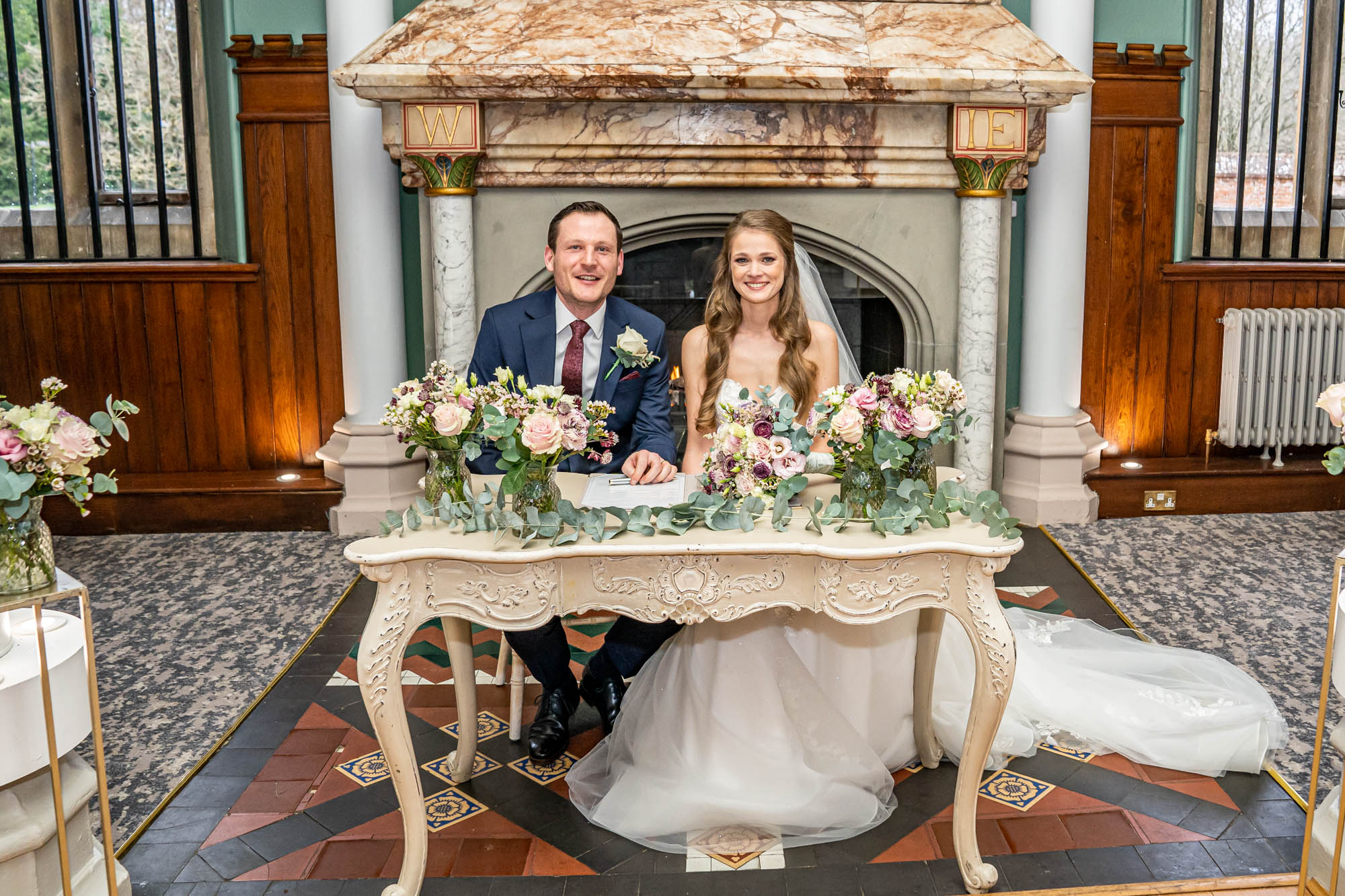 Newlyweds sign the register at wedding ceremony.