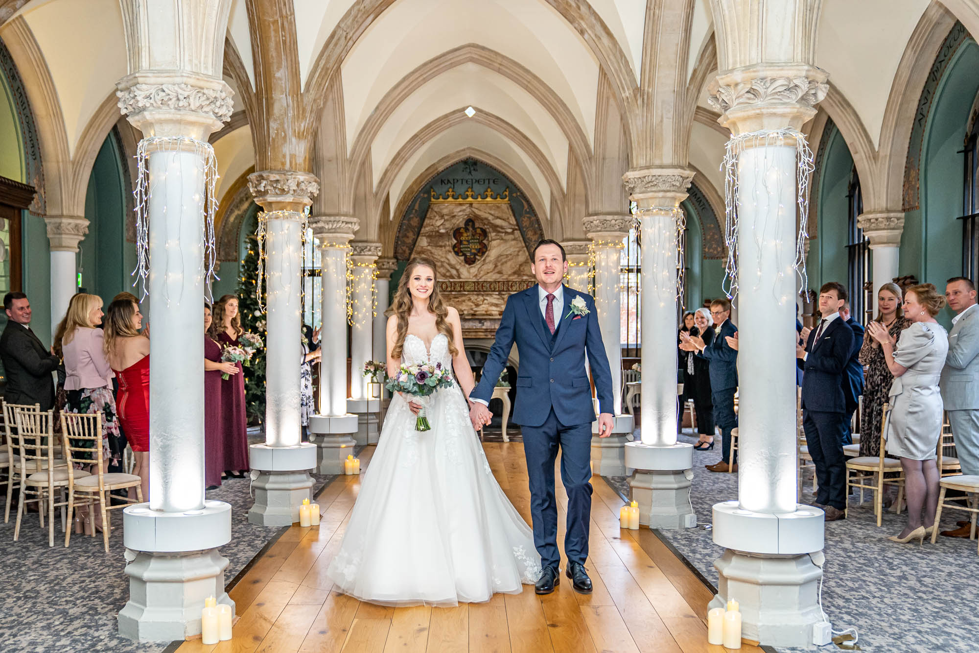 Bride and groom walk down the aisle as newlyweds.