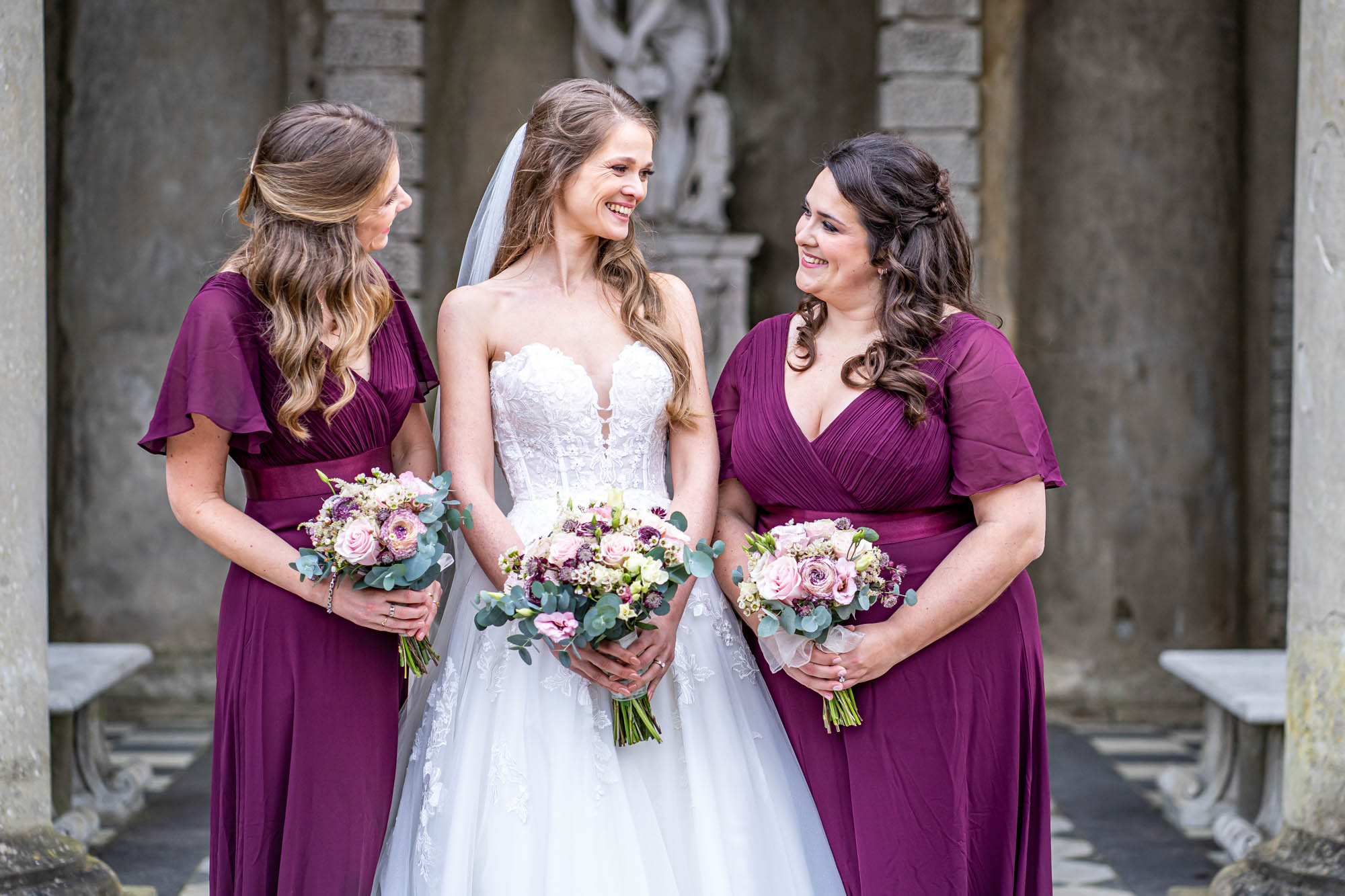 Bride stands with her bridesmaids.
