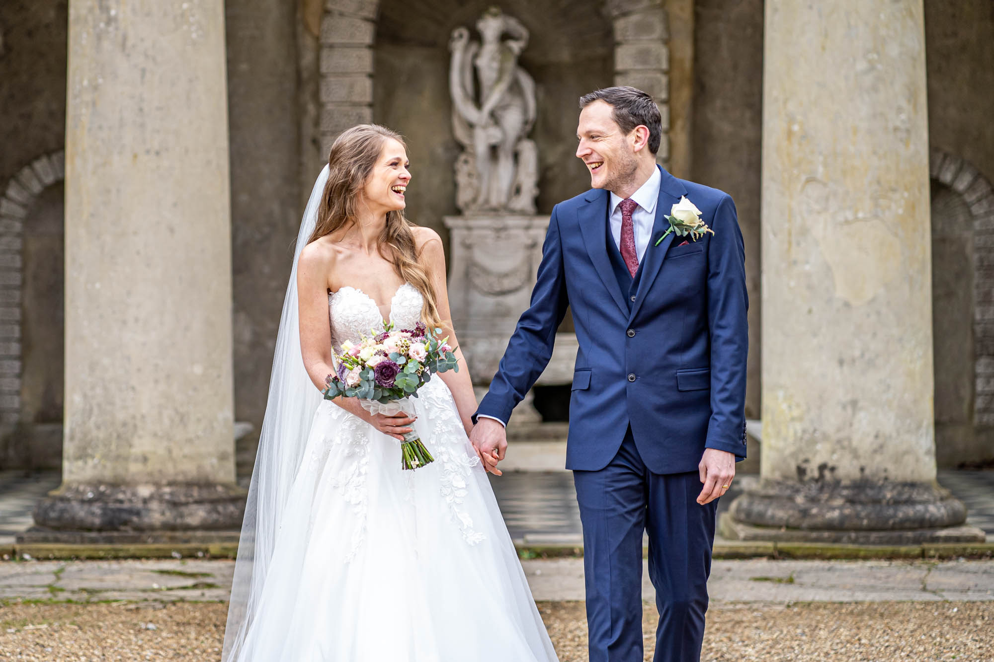 Bride and groom laugh together.