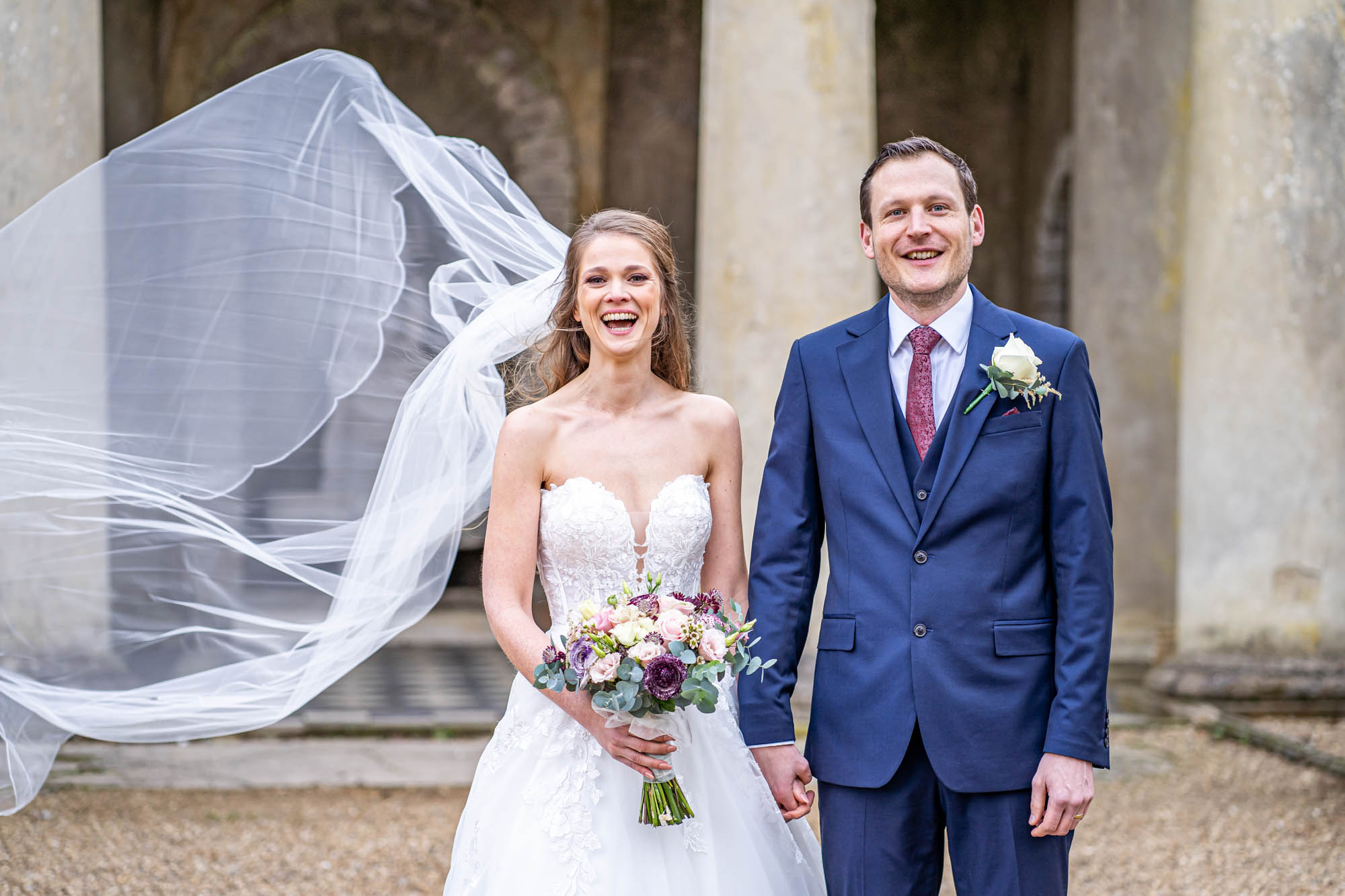 Brides veil blows in the wind.