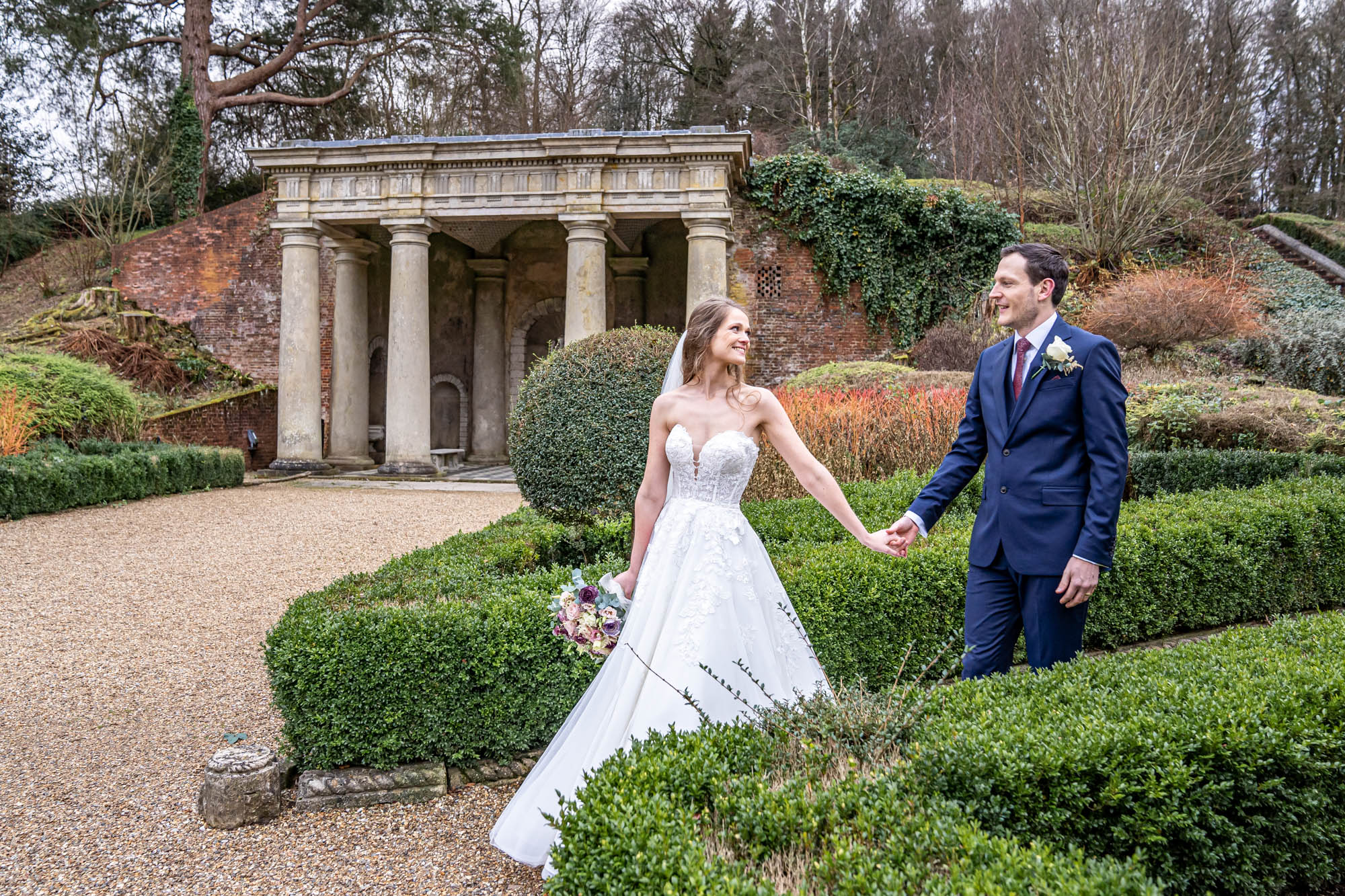 Newlyweds walking together holding hands.