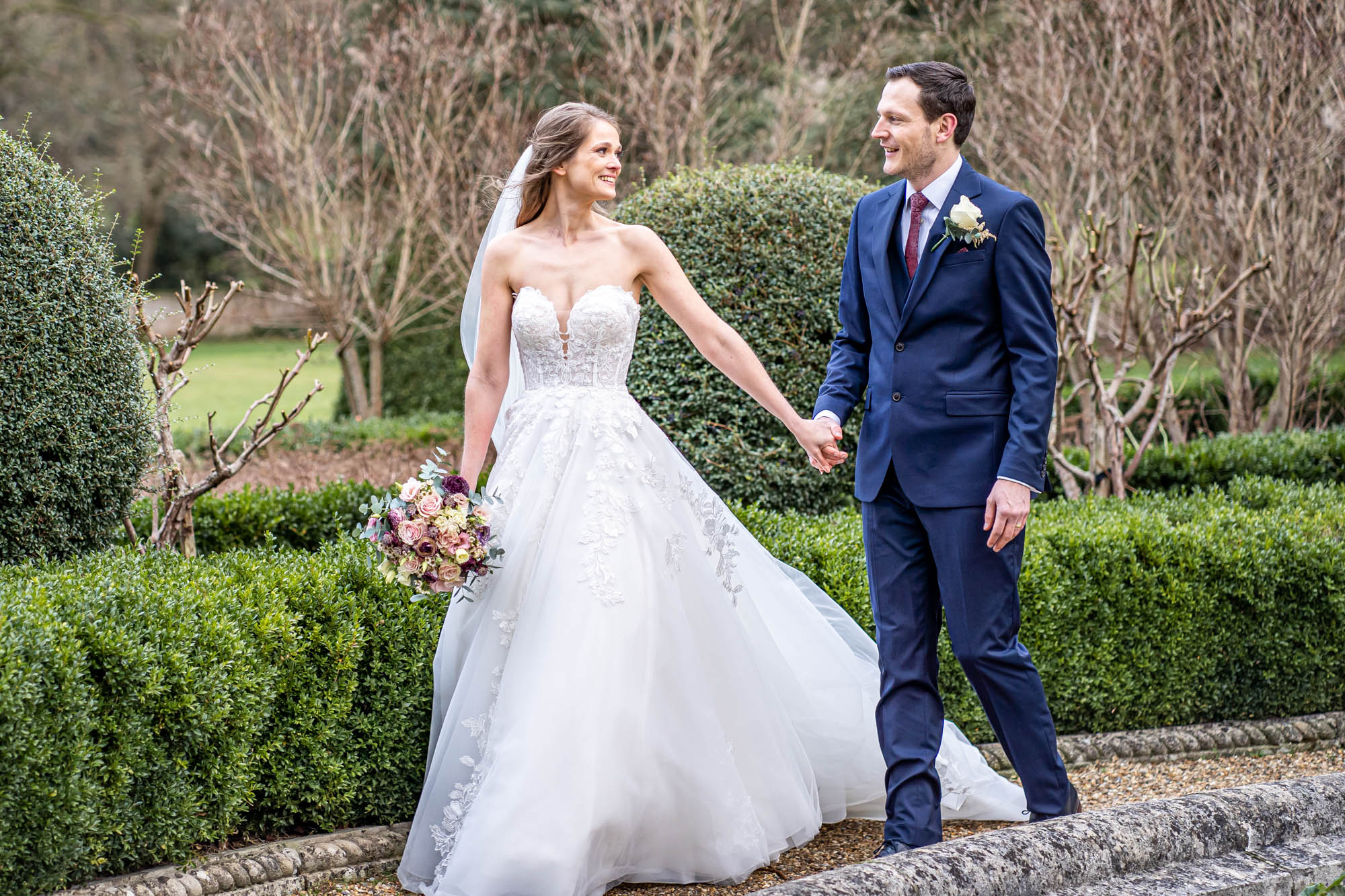 Bride leads groom by his hand.