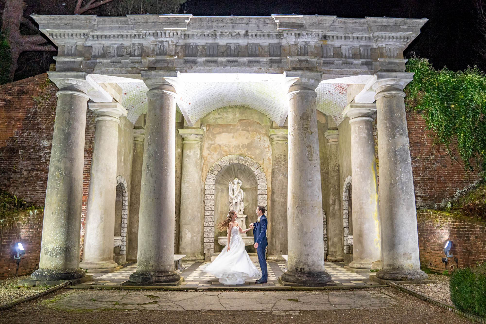 Bride and groom dance together in the dark 