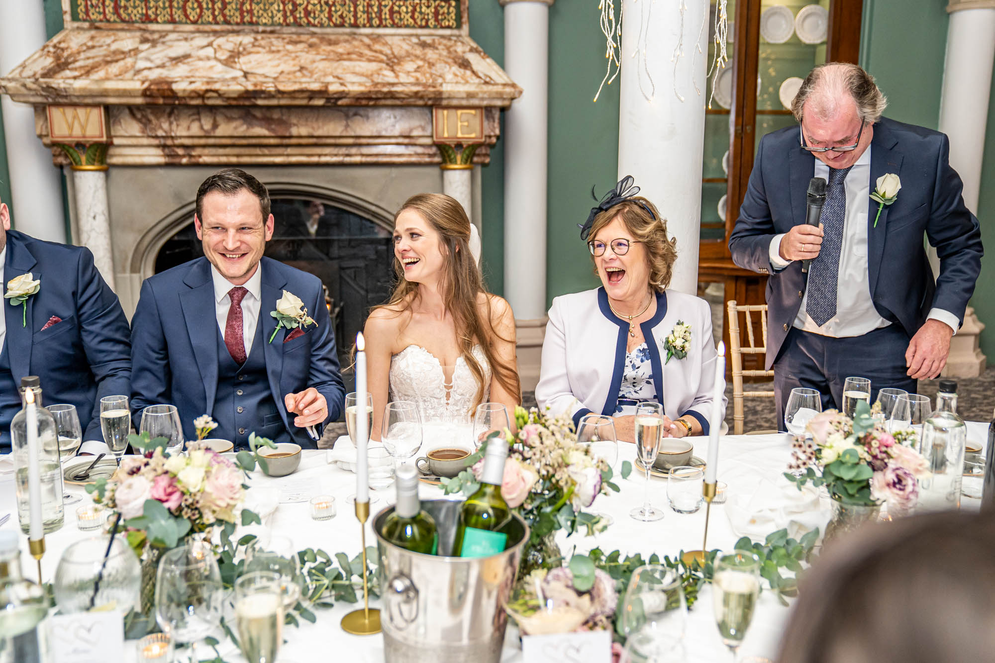 Wedding guests laugh at the speeches.