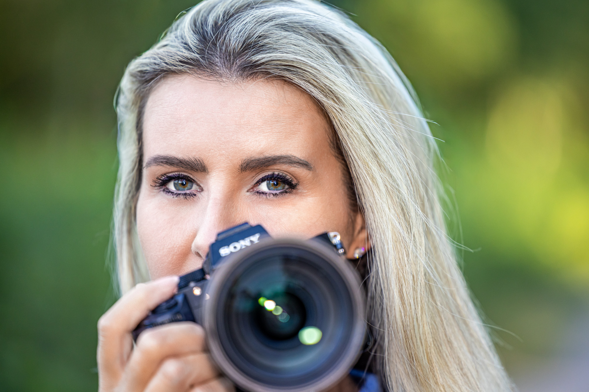 Surrey wedding photographer holding her camera 